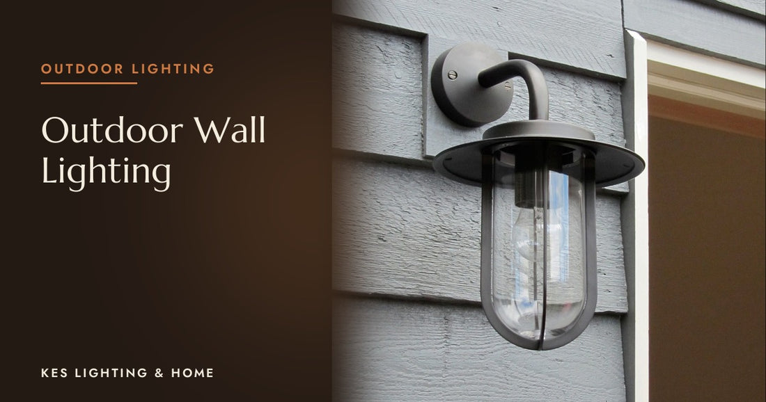 Outdoor wall lantern with a clear shade on grey cladding