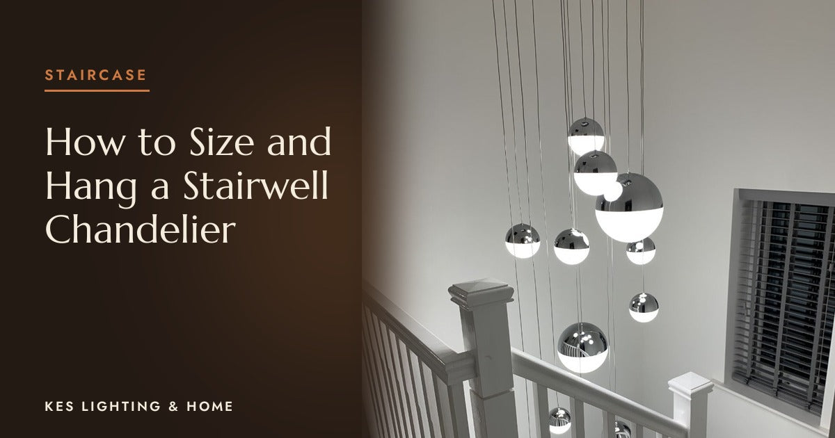 Cluster of mirrored globe pendants hanging down a stairwell
