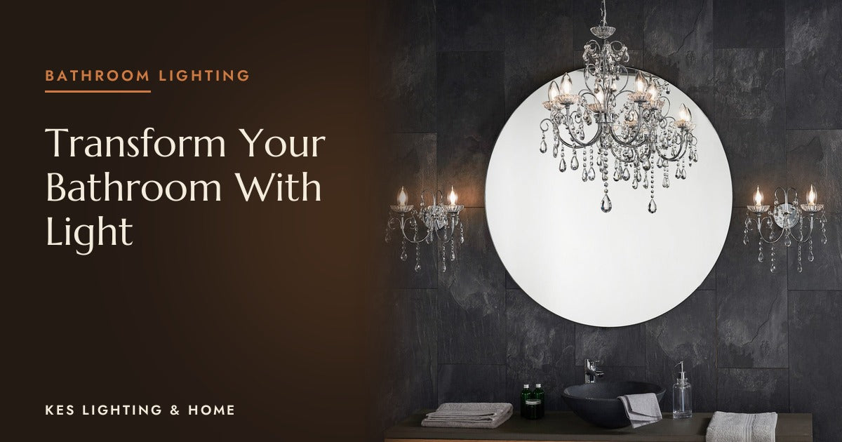Chandelier with clear drops in front of a round mirror on a dark bathroom wall