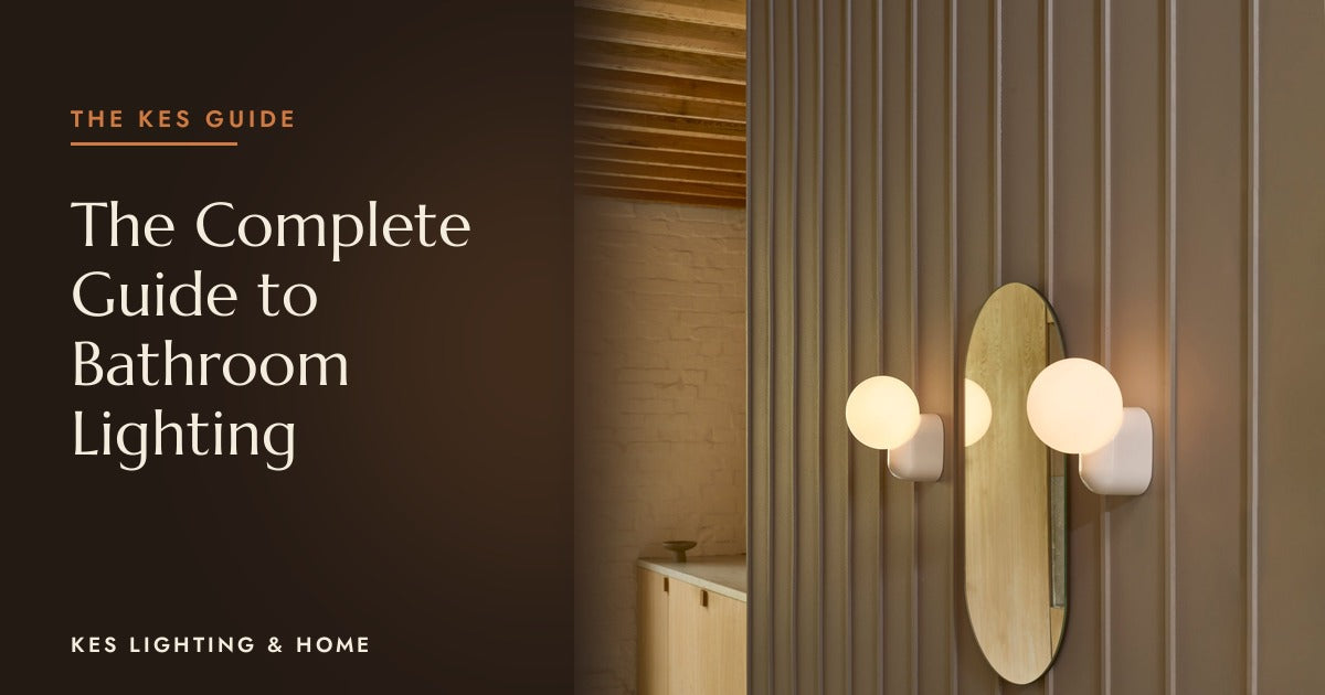 Two globe wall lights beside an oval mirror on a ribbed wall