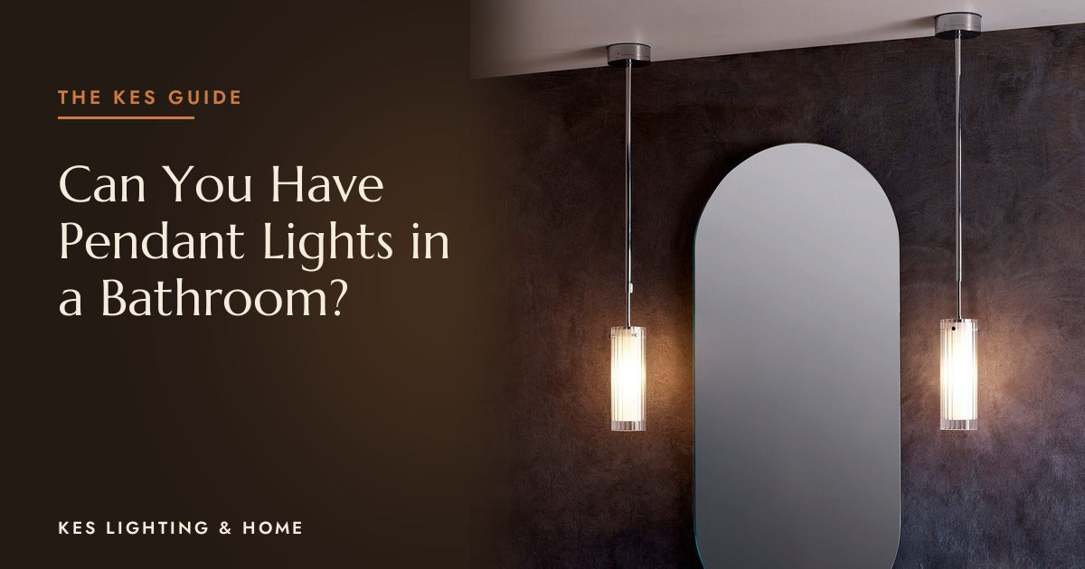Two pendant lights either side of an arched mirror on a dark wall