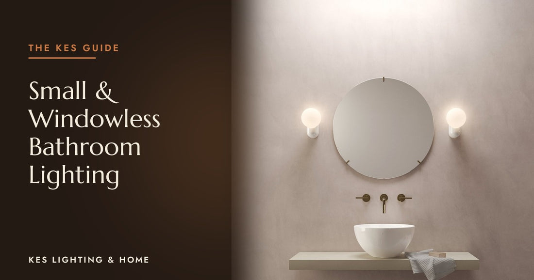 Pair of globe wall lights either side of a round mirror above a basin