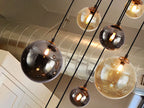 Schuller Dark 9 Light Pendant Light in Black Brass with Glass Shades
