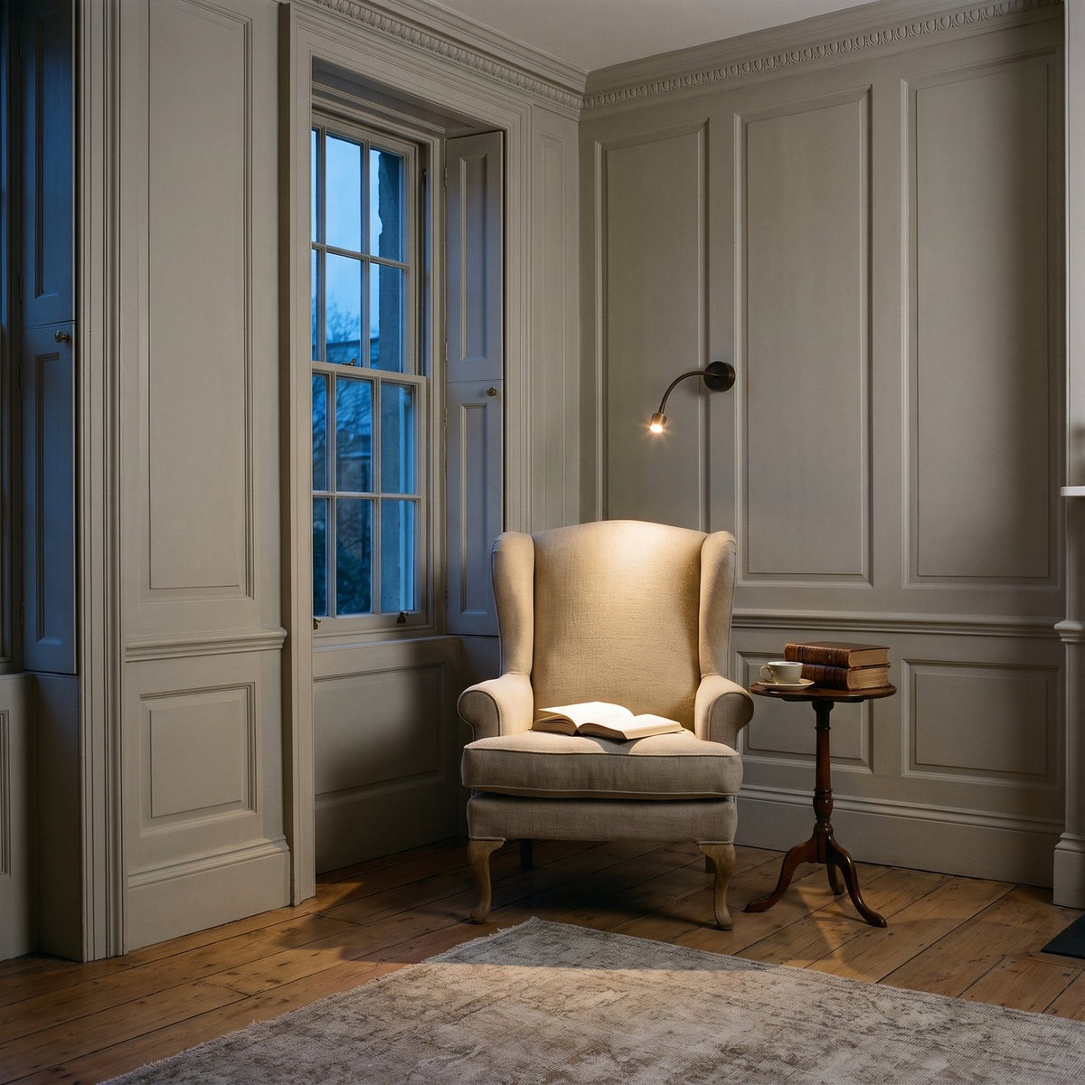 Astro Fosso Switched Reading Light in Bronze lit beside an armchair in a panelled Georgian sitting room