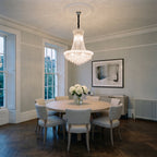 Diyas Alexandra 13 Light Pendant in Polished Chrome with Crystal lit over a dining table in an Edwardian mansion flat