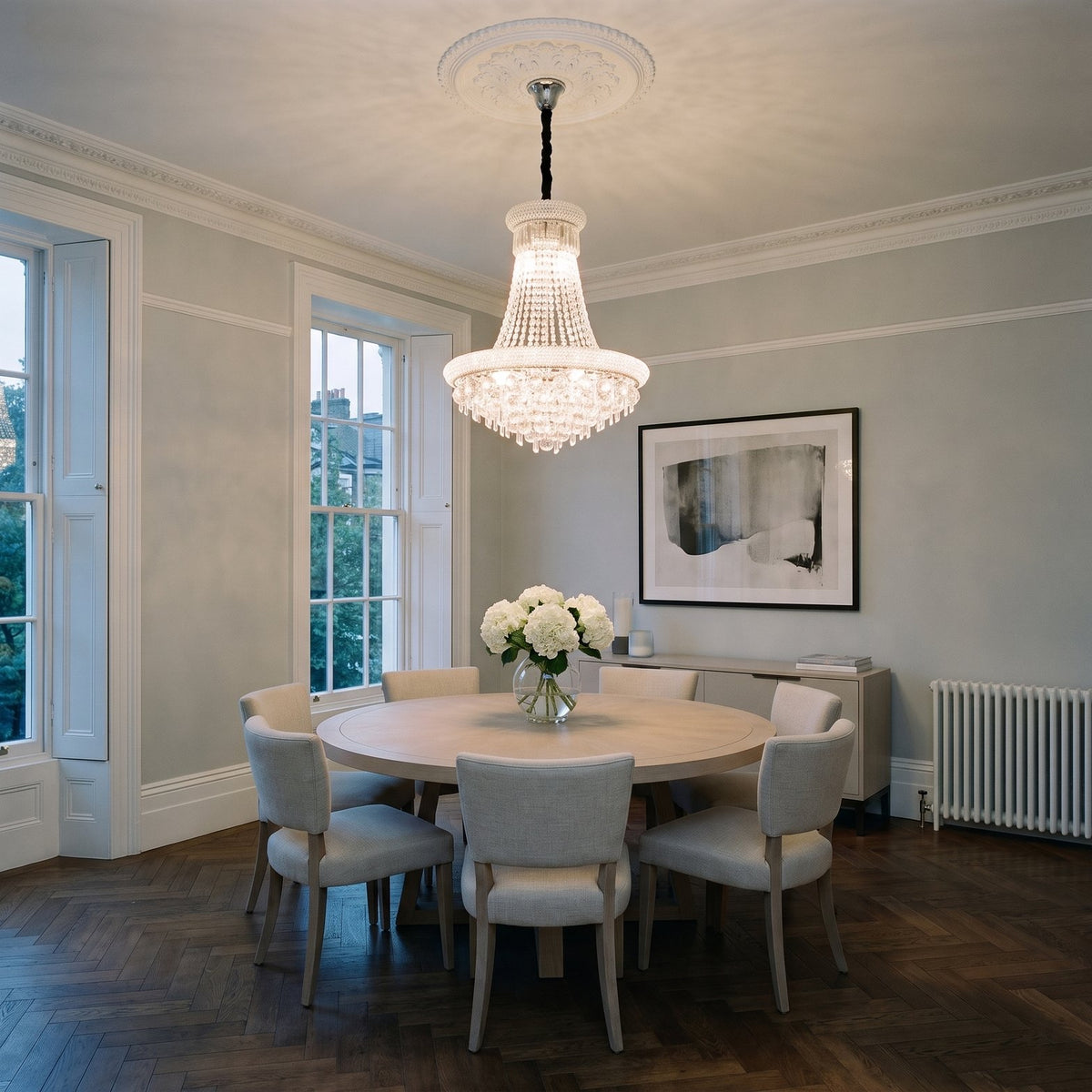 Diyas Alexandra 13 Light Pendant in Polished Chrome with Crystal lit over a dining table in an Edwardian mansion flat