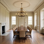 Elstead Amarilli 15 Light Chandelier in Bronze lit over a long dining table in a grand Georgian dining room