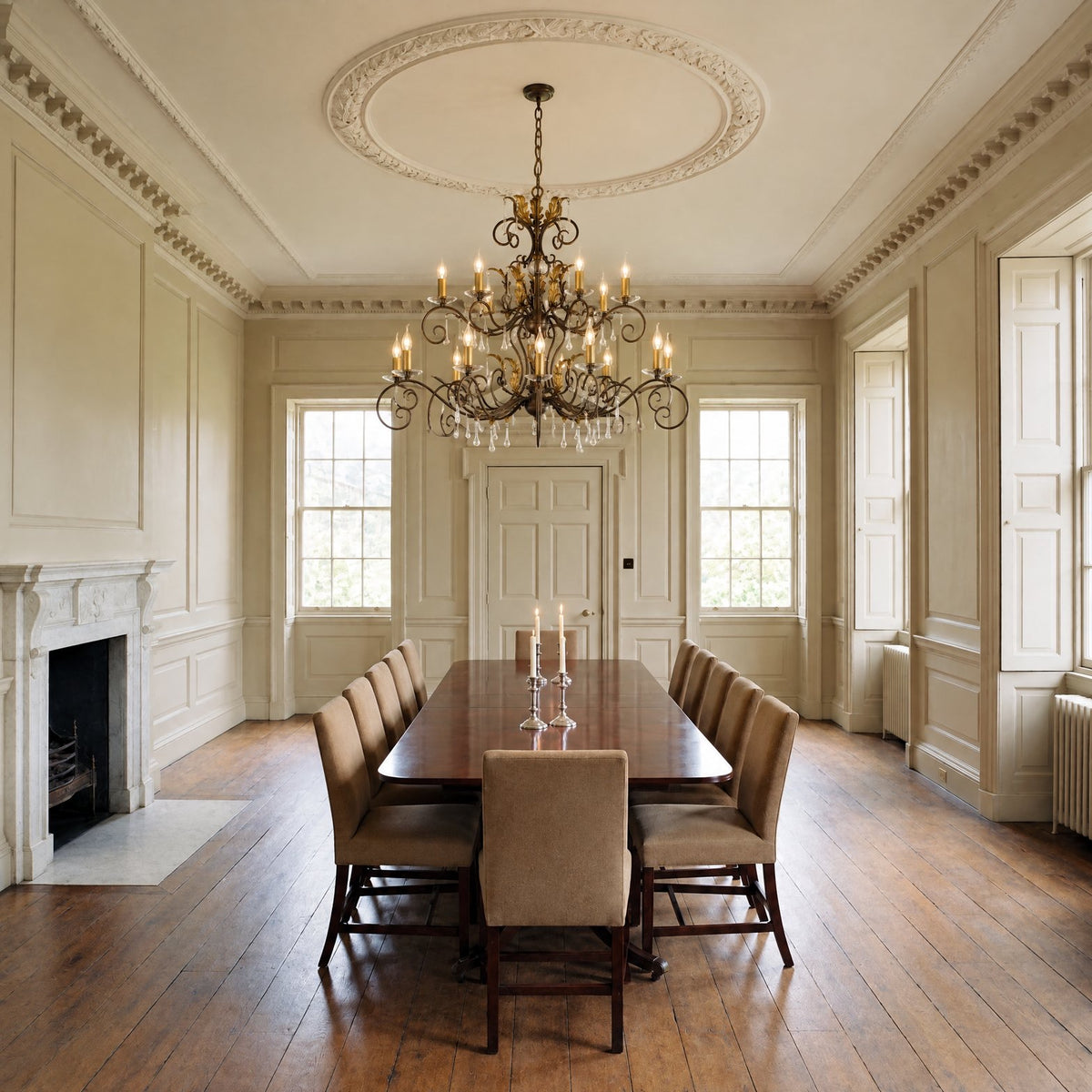 Elstead Amarilli 15 Light Chandelier in Bronze lit over a long dining table in a grand Georgian dining room