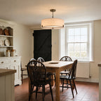 Endon Hayfield 3 Light Pendant in Brushed Bronze with Natural Linen lit over an oak table in a Victorian farmhouse kitchen-diner