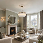 Marietta 5 light pendant in antique brass with a pair of Marietta wall lights, in a sage green living room with a bay window