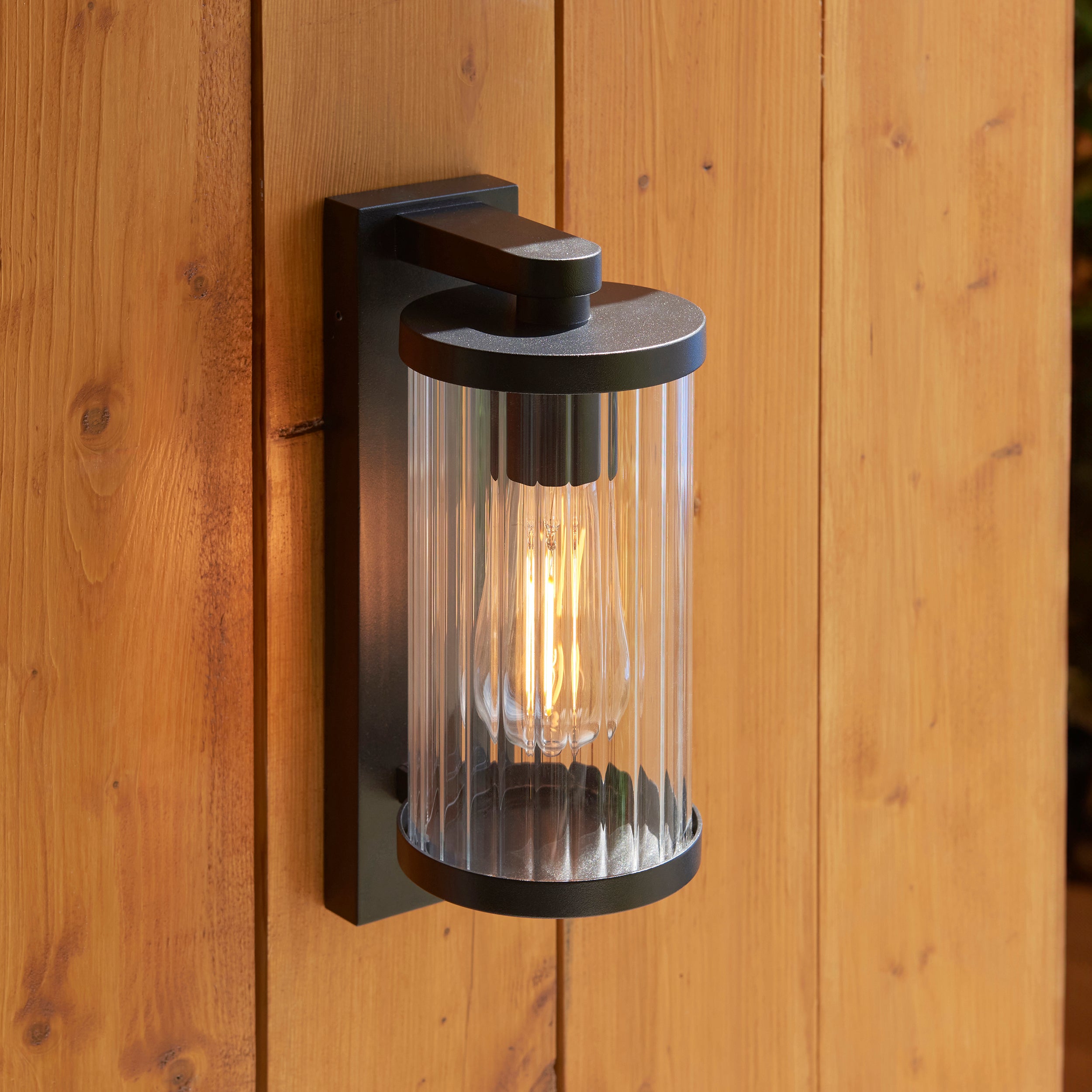 Endon Newcombe Outdoor Wall Light in Matt Black and Clear Ribbed Glass