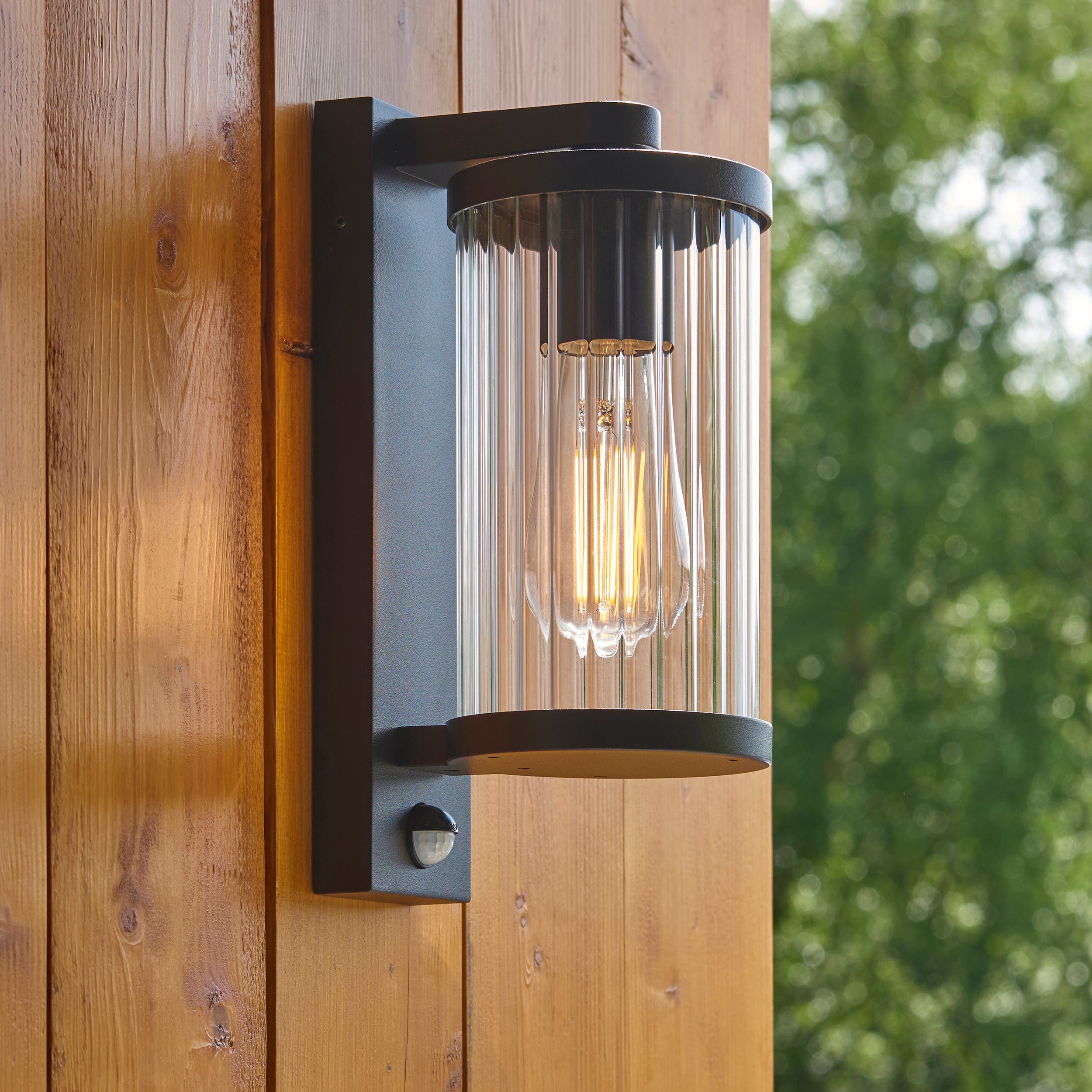 Endon Newcombe Outdoor Wall Light in Matt Black and Clear Ribbed Glass
