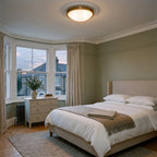 Hinkley Collier 3 Light Flush Ceiling Light in Heritage Brass lit in a sage green Edwardian bedroom