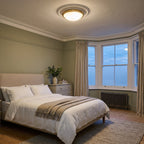 Hinkley Collier 3 Light Flush Ceiling Light in Heritage Brass lit in a sage green Edwardian bedroom