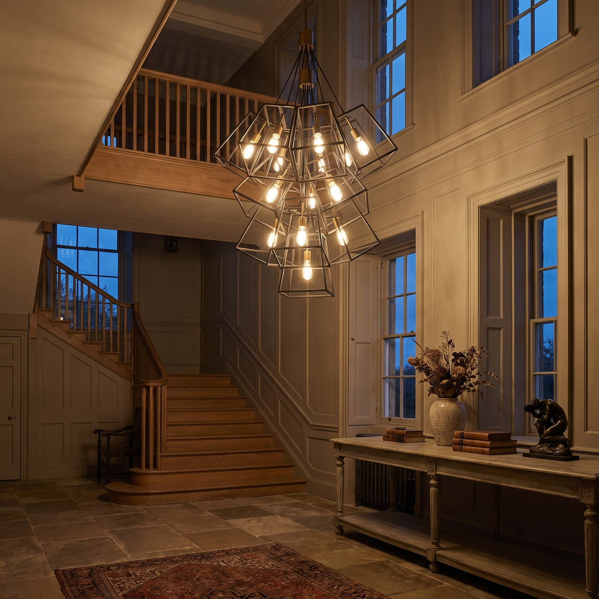 Hinkley Fulton Large 13 Light Chandelier in Bronze, lit, in a styled room. Editorial image for the Bronze Pendant Lights collection.