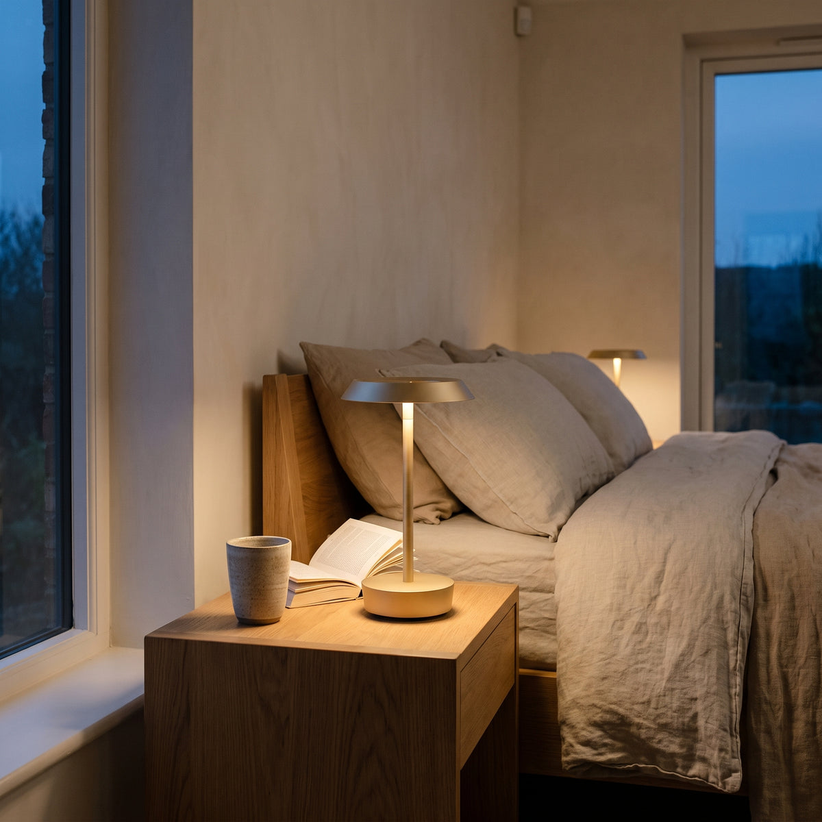 Astro Halo Portable Light in Bronze, lit, in a styled room. Editorial image for the Bronze Table Lamps collection.