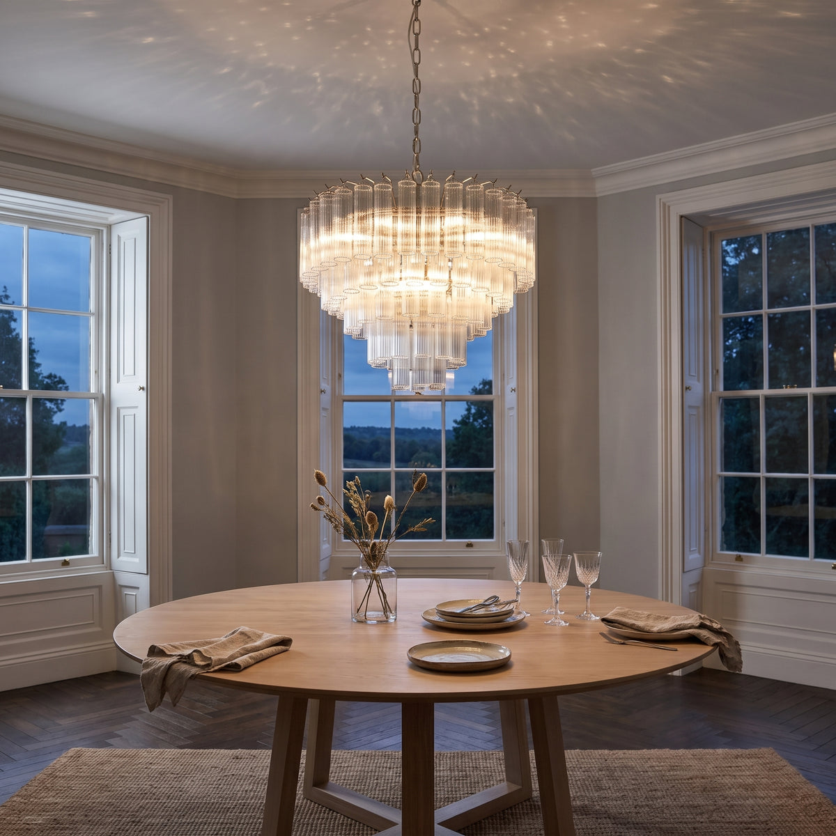 Endon Toulouse 12 Light Pendant Light in Bright Nickel with Clear Ribbed Glass, lit, in a styled room. Editorial image for the Chrome and Nickel Ceiling Lights collection.