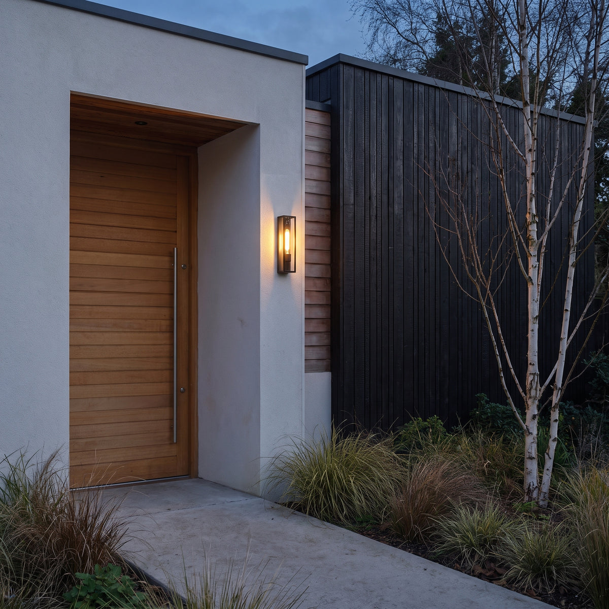 Astro Harvard Outdoor Wall Light in Textured Black, lit, in a styled room. Editorial image for the Matt Black Modern Outdoor Wall Lights collection.