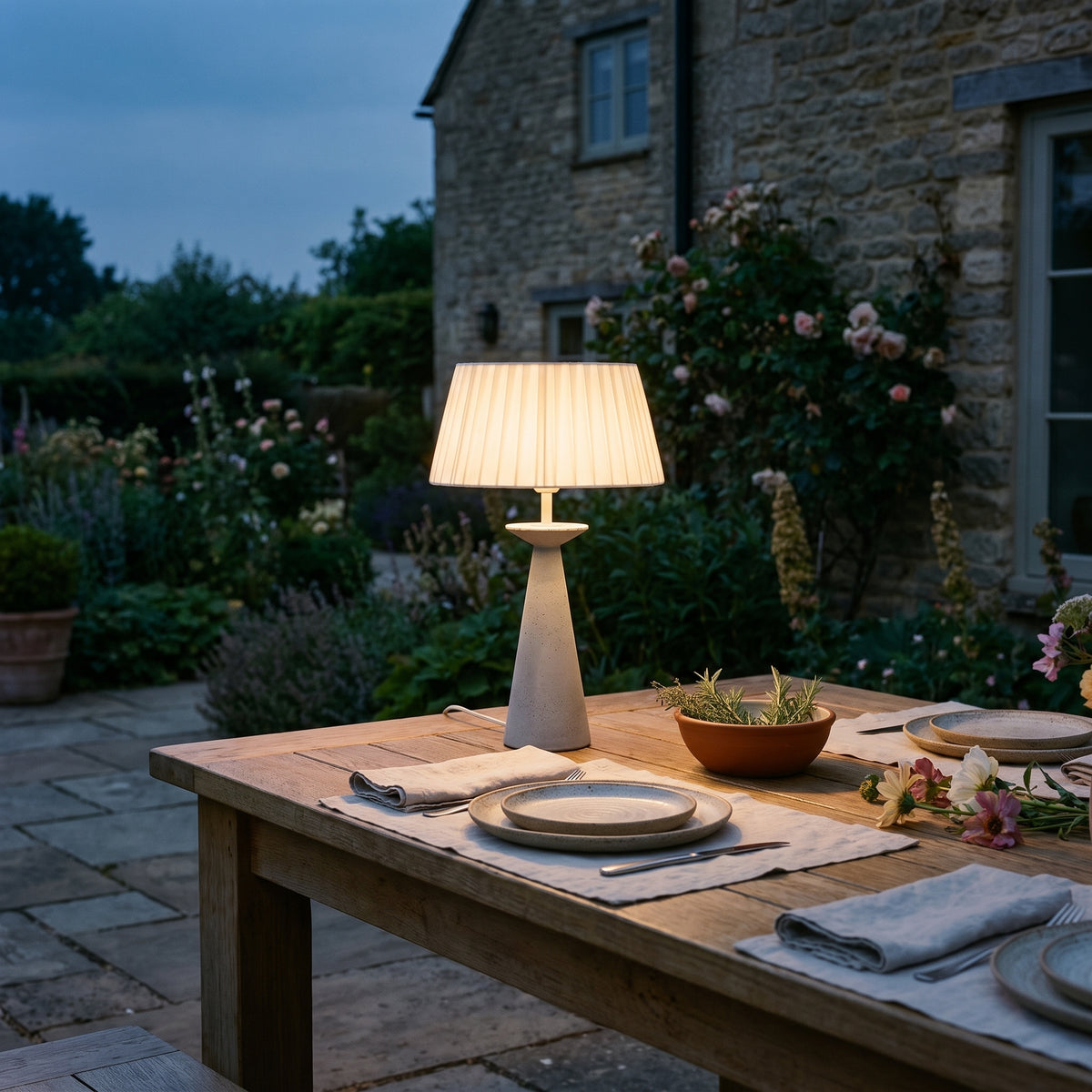 Novena Capo Cordless Rechargeable Table Lamp, lit, in a styled room. Editorial image for the Rechargeable Table Lamps collection.