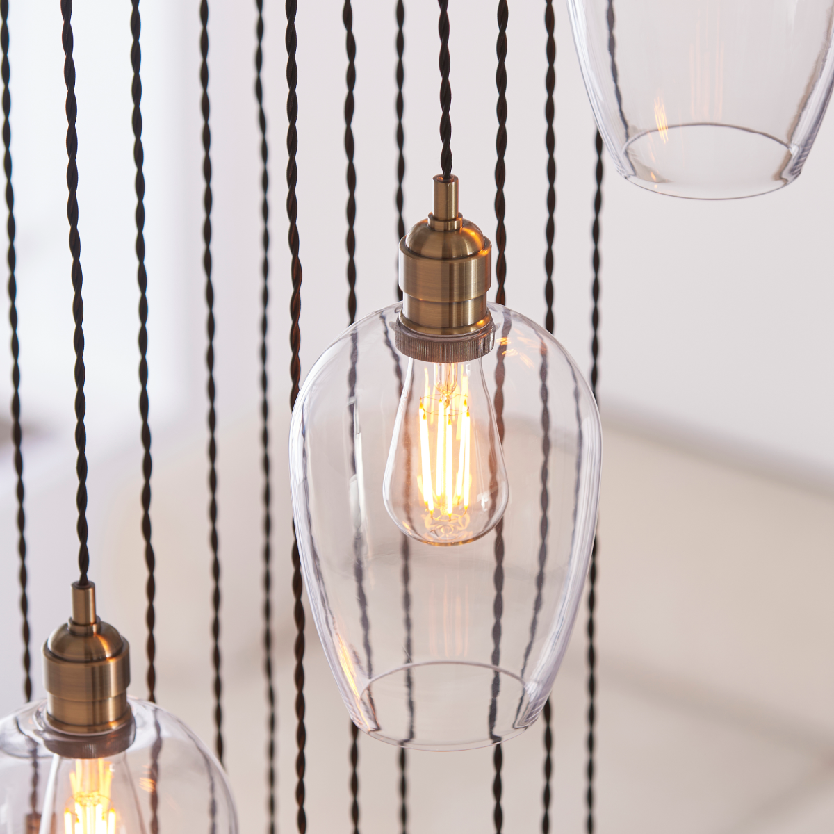 Novena Lavaur 13 Light Cascade Pendant Light in Antique Brass with Clear Glass Shades