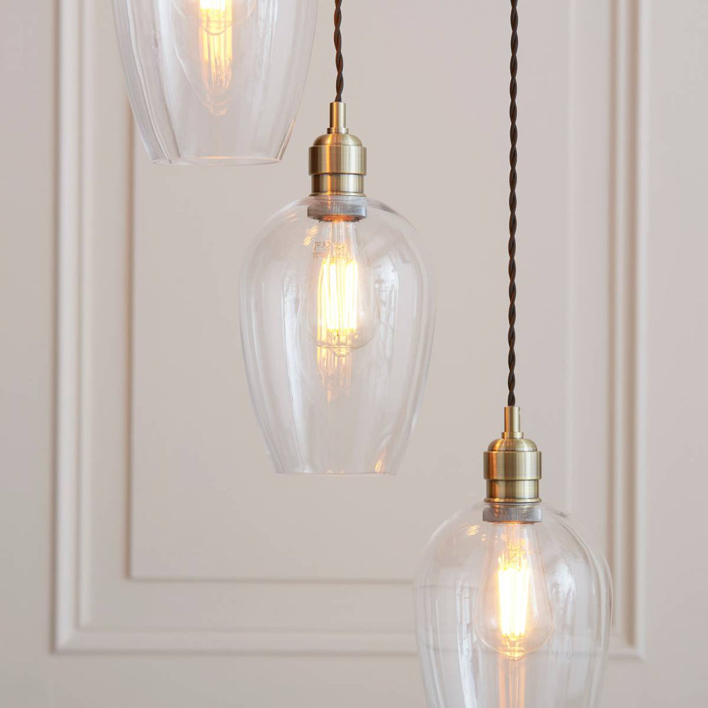 Novena Lavaur 7 Light Cascade Pendant in Antique Brass with Clear Glass Shades