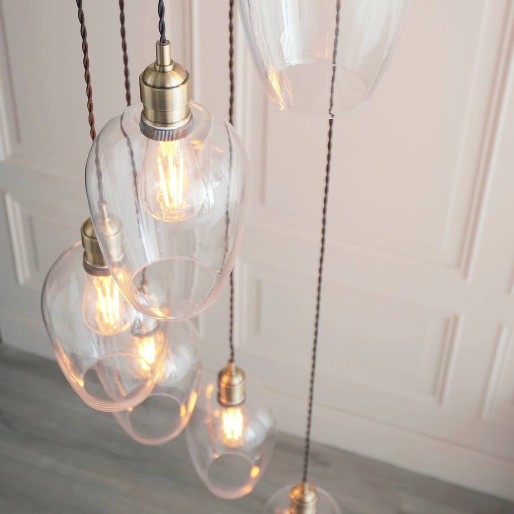 Novena Lavaur 7 Light Cascade Pendant in Antique Brass with Clear Glass Shades