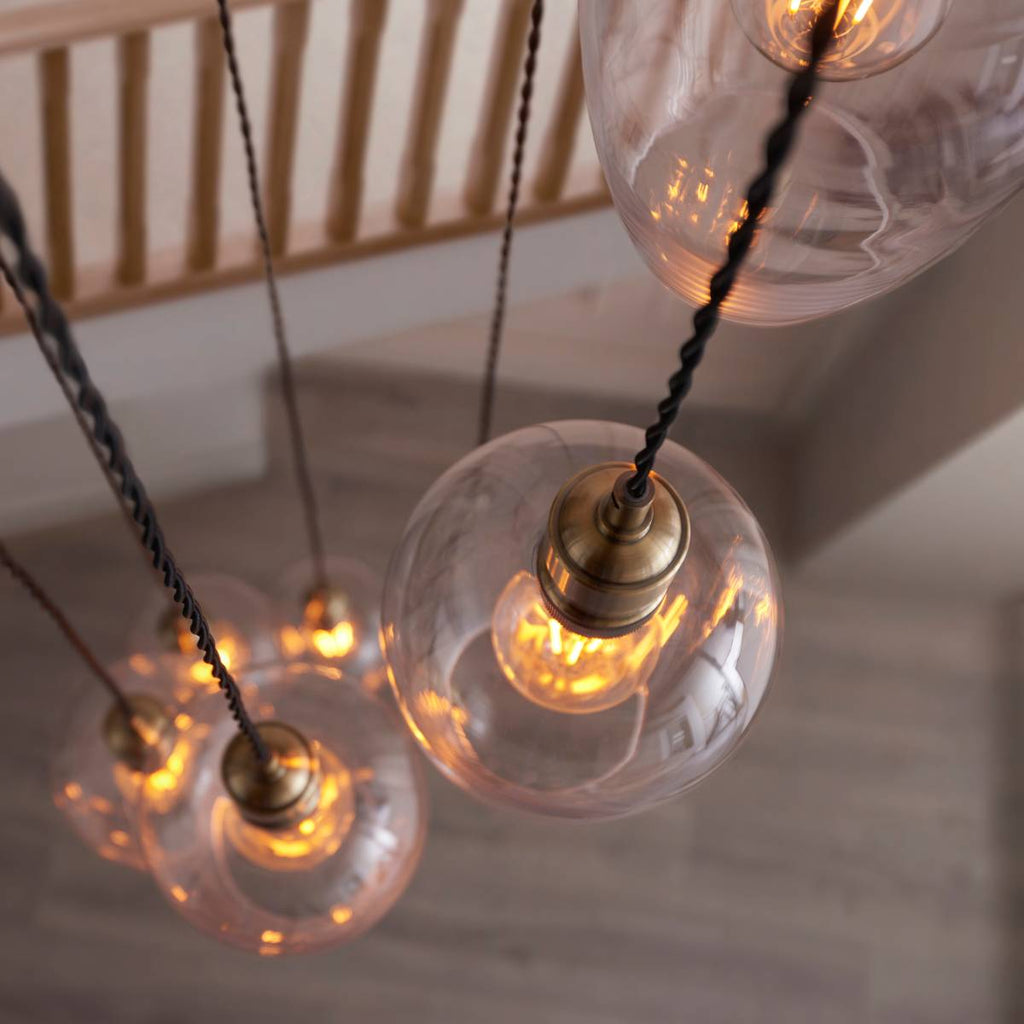 Novena Lavaur 7 Light Cascade Pendant in Antique Brass with Clear Glass Shades