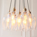 Novena Tarn 7 Light Cluster Pendant in Antique Brass with Clear Glass Shades