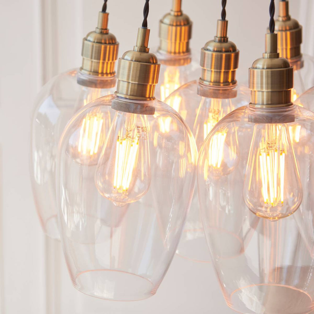 Novena Tarn 7 Light Cluster Pendant in Antique Brass with Clear Glass Shades