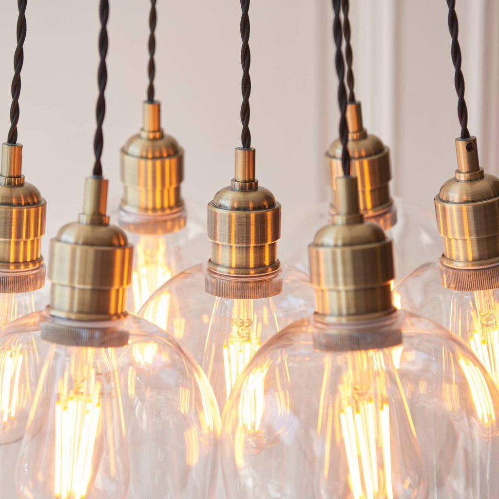Novena Tarn 7 Light Cluster Pendant in Antique Brass with Clear Glass Shades