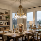 Hinkley Plantation 5 light chandelier in burnished brass above a dining table