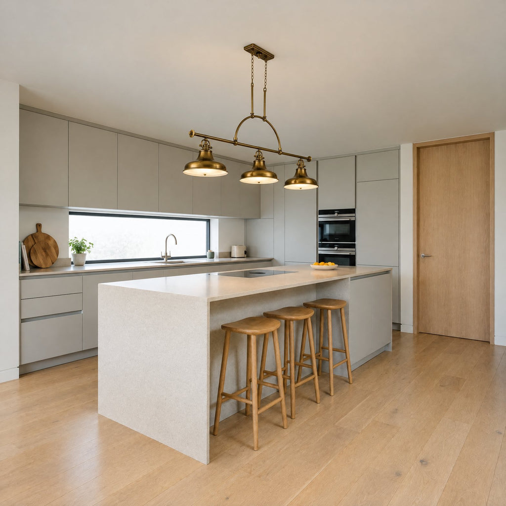 Quoizel Emery 3 Light Bar Pendant in Weathered Brass lit over a stone kitchen island in a contemporary kitchen